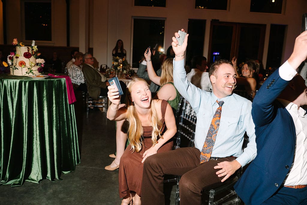 wedding guests are laughing playing game at wedding reception at Sassafras Springs Vineyard and Winery
