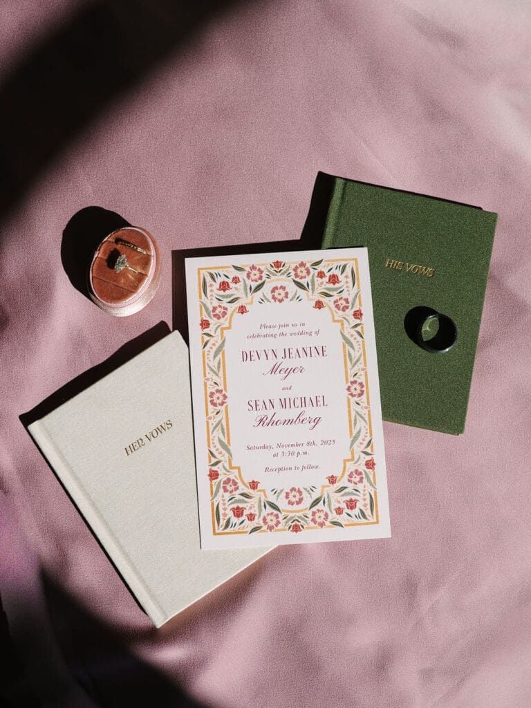 flat lay of vow books and invitation