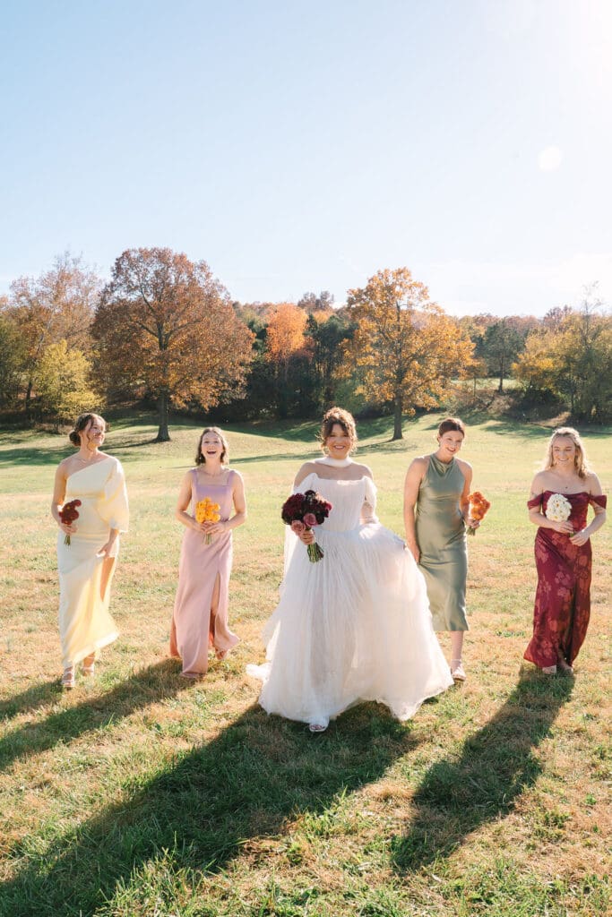bride and multi-colored bridesmaids walking together