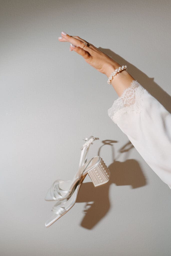 editorial flash photo of bride throwing her shoes
