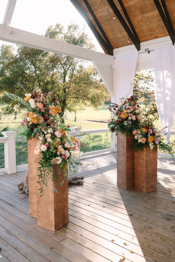 fall colored florals for ceremony space at Sassafras Springs Vineyard and Winery