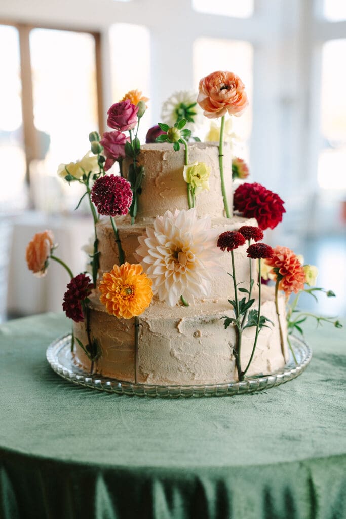 cake with jewel toned flowers