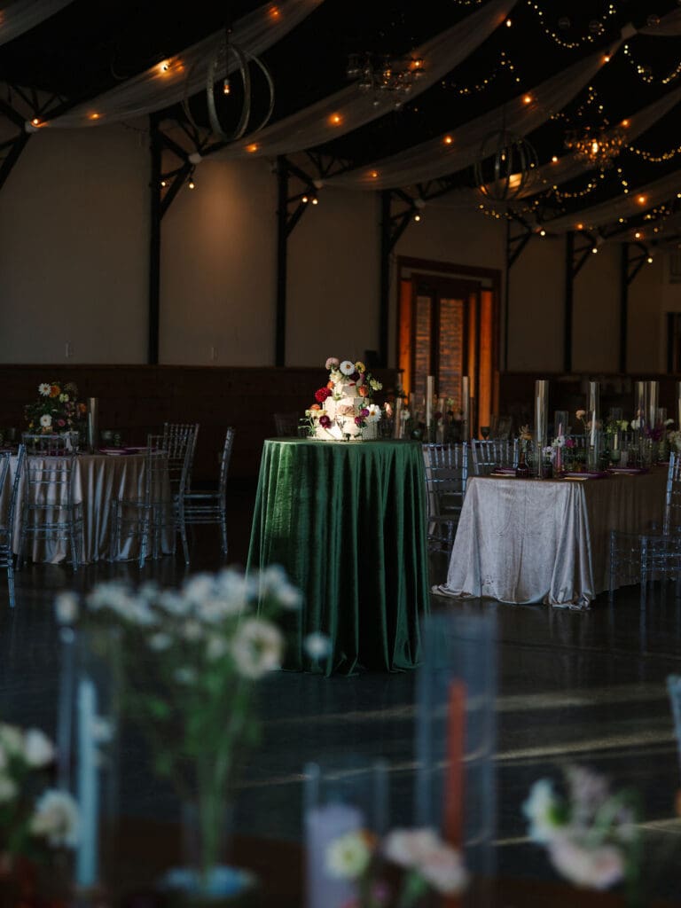 wide shot of reception space featuring cake pedestal at Sassafras Springs Vineyard and Winery