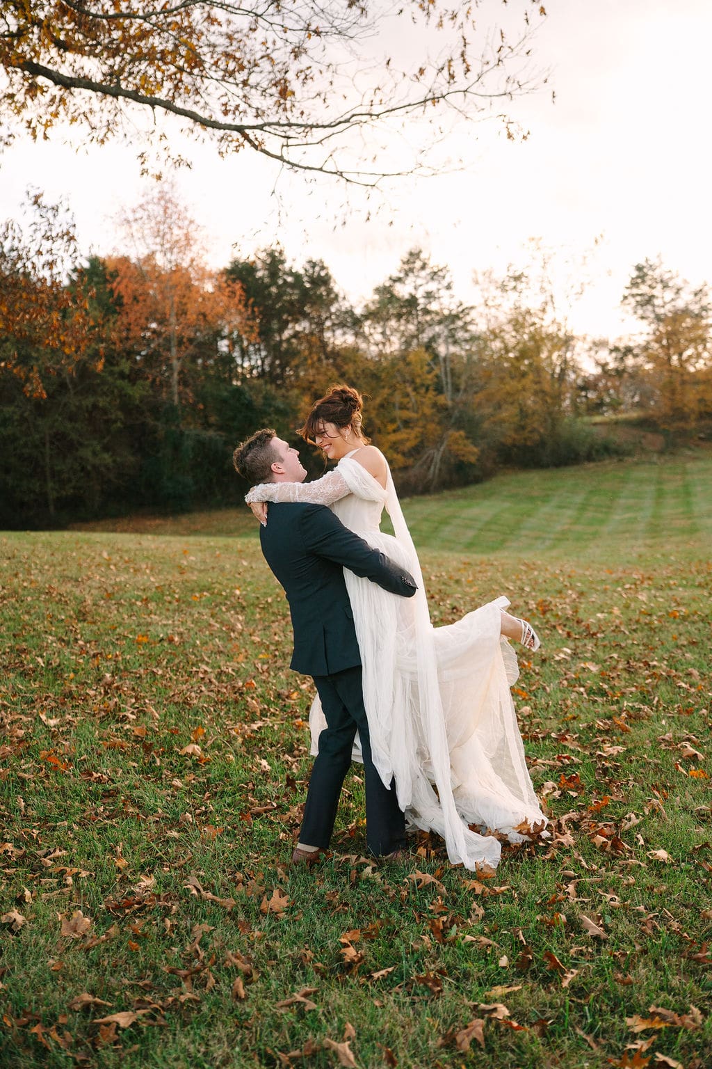 bride and groom twirling outdoors at Sassafras Springs Vineyard and Winery during golden hour