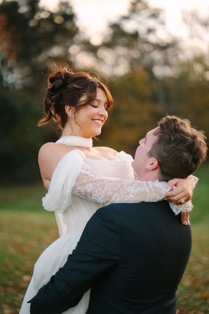 close up of bride and groom twirling outdoors at Sassafras Springs Vineyard and Winery