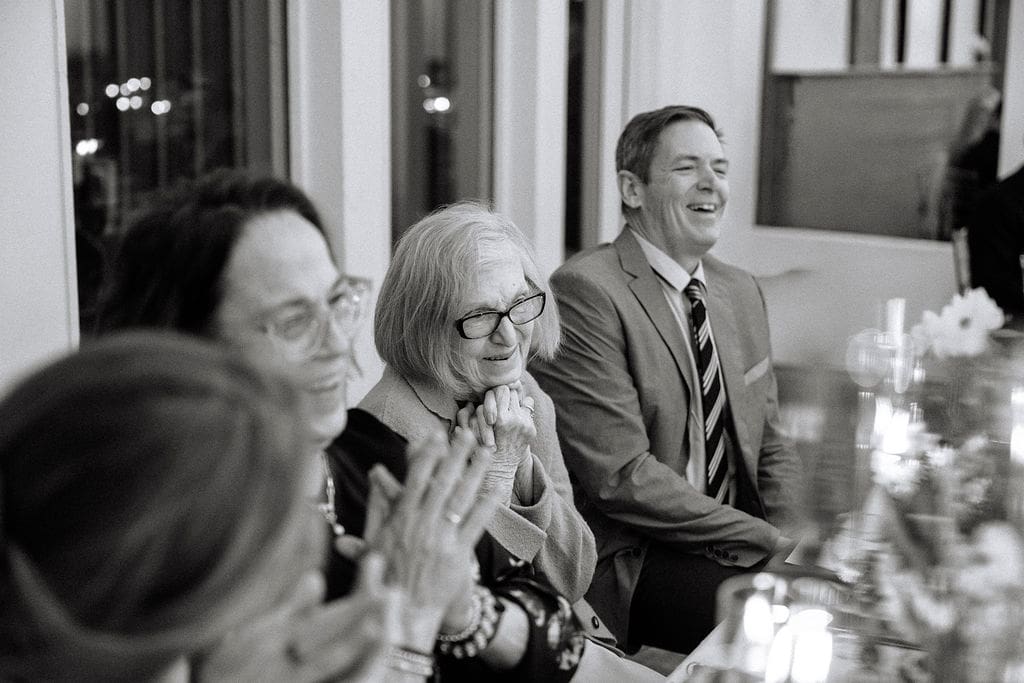 grandmother looks emotionally at bride while toasts are done